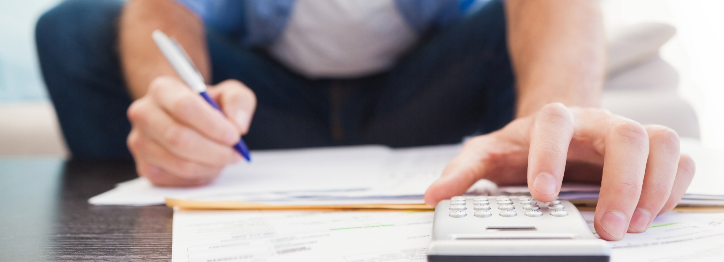 API banner image, hand writing and working on a calculator